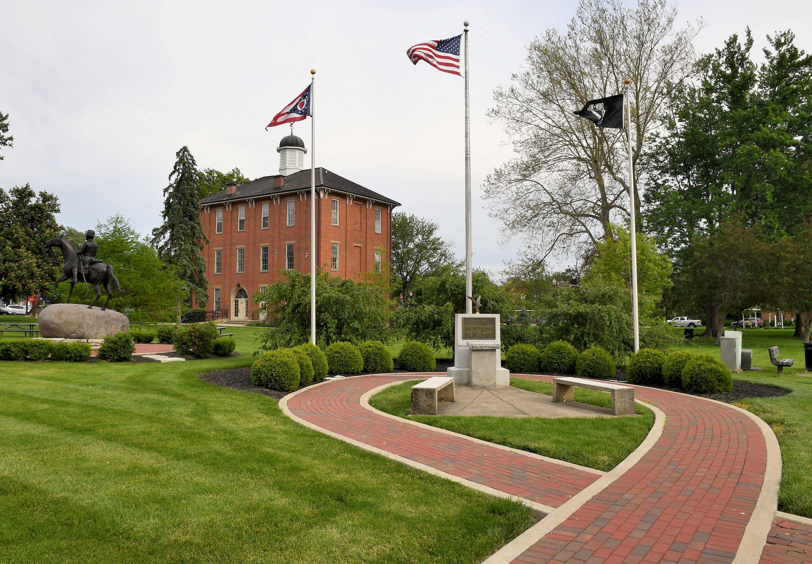 An outside view of town hall and a memorial